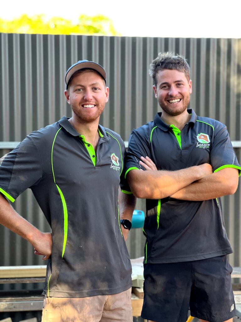 Matt and Jon from Imagine Build standing infront of a fence